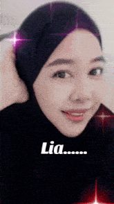 a woman wearing a black hijab with the word lia written on it