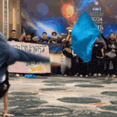 a man is doing a handstand in front of a sign that says gmm