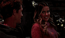 a man and a woman are standing next to each other smiling