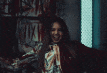 a person with blood on their face is standing in front of a sign that says ' nvx ' on it
