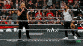 two wrestlers in a wrestling ring with the word ve better on the floor
