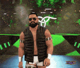 a man with a beard and sunglasses stands on a stage with a tnw logo in the background