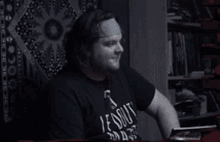 a man wearing a shirt that says ' stout ' on it is covering his face