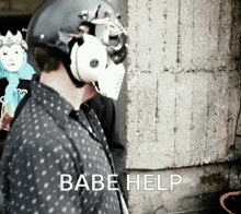 a man wearing a mask and a helmet is asking for help