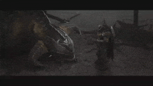 a man with a shield is standing next to a large monster with horns .