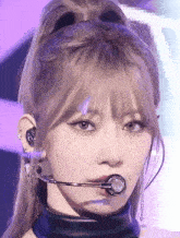 a close up of a woman wearing a microphone