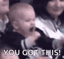 a baby is crying in a crowd of people with the words `` you got this '' written on the bottom .
