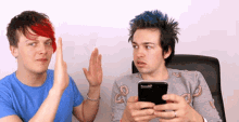a man with red hair is giving a high five to another man with blue hair