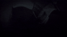 a purple light is coming out of a dark room
