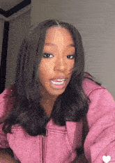 a woman wearing a pink jacket with a zipper on it
