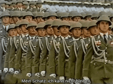 a group of soldiers are marching in a line with the words mein schatz ich kann nicht bleiben in the corner