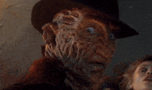a close up of a freddy krueger with a hat on