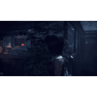 a woman stands in front of a window with a red light shining through it