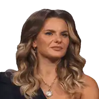 a woman wearing a necklace with a coin on it looks angry