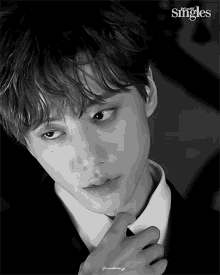 a black and white photo of a young man in a suit and tie with singles written on the bottom