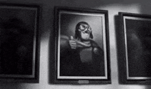 a black and white painting of a man in a helmet giving a thumbs up