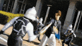 a man in a suit and tie is being attacked by a group of ninjas