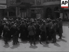 a large group of people are gathered in front of a building that says ap on it