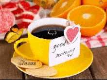 a cup of coffee on a saucer with a card that says good morning