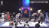 a wrestling match is being played in a ring and the referee is wearing a jersey with the number 19 on it