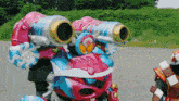 a pink and blue robot with a sticker on the front that says ' samurai '