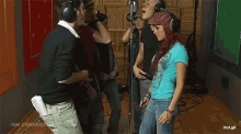 a group of people are standing in a room with a watermark that says rbd.gif