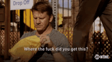 a man is holding a yellow bag and asking where the fuck did you get this ..