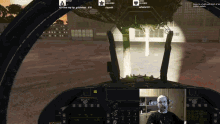 a man sitting in a cockpit of an airplane with a tree in the background and a few messages visible