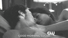 a black and white photo of a man and woman laying in bed with the words good morning sugar below them