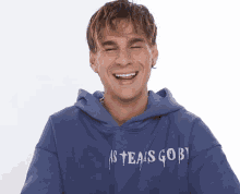 a man wearing a hoodie that says ' sgob ' on it is laughing