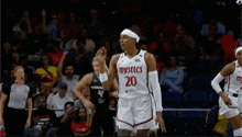 a female basketball player wearing a jersey that says mystics on it