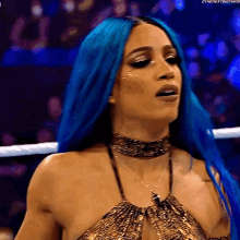 a woman with blue hair is wearing a gold top and a choker