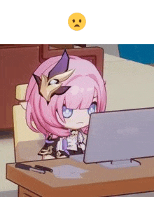 a girl with pink hair is sitting at a desk looking at a laptop computer .
