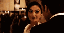 a man and a woman are looking at each other .