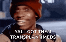 a man wearing a red beanie is smiling and talking about getting a transplant .