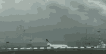 a united airlines plane is on a runway with a man standing on top of it