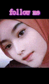 a close up of a woman wearing a hijab with the words follow me written above her
