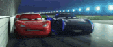 lightning mcqueen and jackson storm from cars are racing on a race track