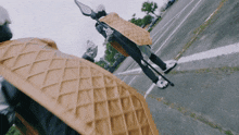 a person wearing a waffle costume is walking down the street