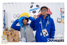 a man holding a sign that says respect stands next to a woman wearing a wig
