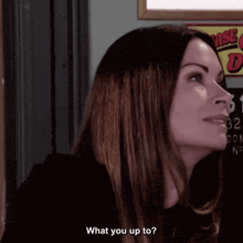 a woman is asking what you up to in front of a sign that says 32