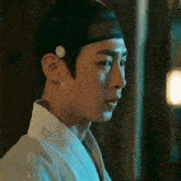 a close up of a man 's face with a white button on his ear