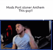 a man in a blue shirt is sitting in front of a screen that says mods port stoner anthem this guy