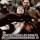 a group of soldiers are fighting each other and one of them is holding another soldier .