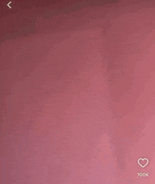 a blurry picture of a baby girl with long hair against a pink background .