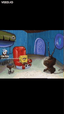 a cartoon of spongebob sitting in a chair watching a tv