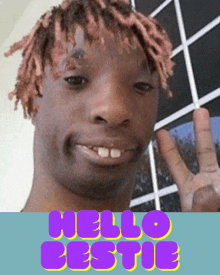 a man with pink hair is smiling and giving a peace sign in front of the words hello bestie