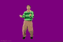 a man in a green and green striped shirt and khaki pants is standing in front of a purple background .