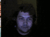 a man wearing headphones looks at a blue light coming out of his mouth
