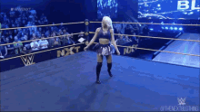 a woman in a wrestling ring with the word nxt on the side